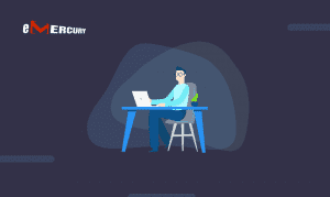 A focused individual working on customer psychology research using a laptop in a modern, minimalist office setup with the emercury logo displayed in the upper left corner.