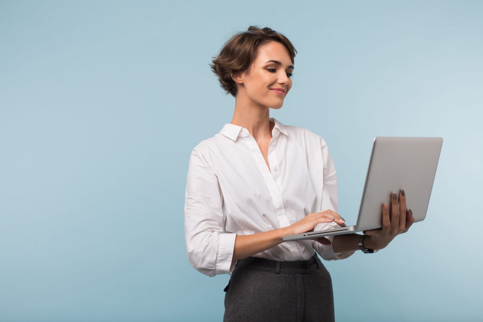 happy subscriber looks at personalized email on her laptop